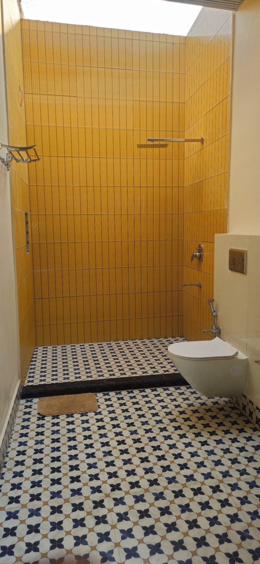 Bathroom with yellow tile and patterned floor