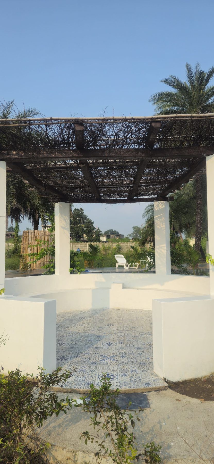 White pergola by the pool, morning